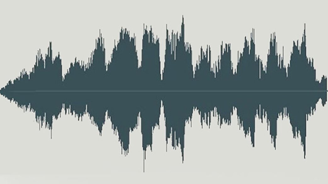 A dark teal audio waveform visualisation showing the symmetrical peaks and troughs of sound waves, displayed horizontally against a pale grey background.